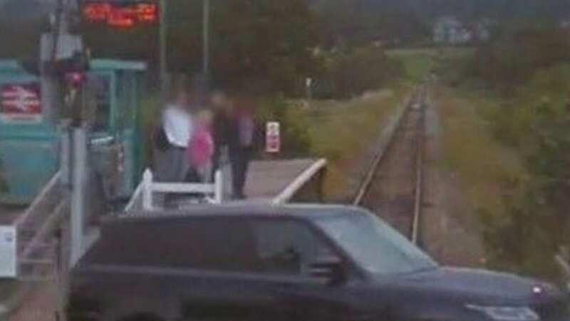 Horror moment man ignores signs at level crossing and drives into path of train