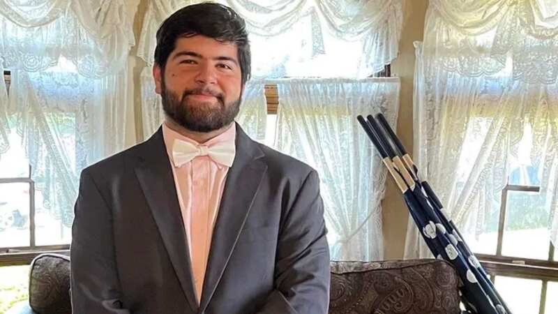 Robert Bush posing in a dark suit jacket and pick shirt with a white bow tie in a photo the family have shared on a GoFundMe that they have set-up (Image: LeeAnn Mazzillo/gofundme)