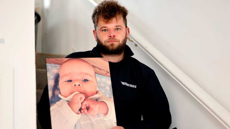 Dom Sage is pictured holding a photograph of tragic son Mason (Image: John Myers)