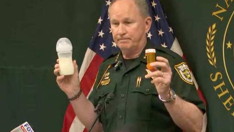 Nassau County Sheriff Bill Leeper holding a bottle of formula and pill bottle at a press conference (Image: First Coast News)