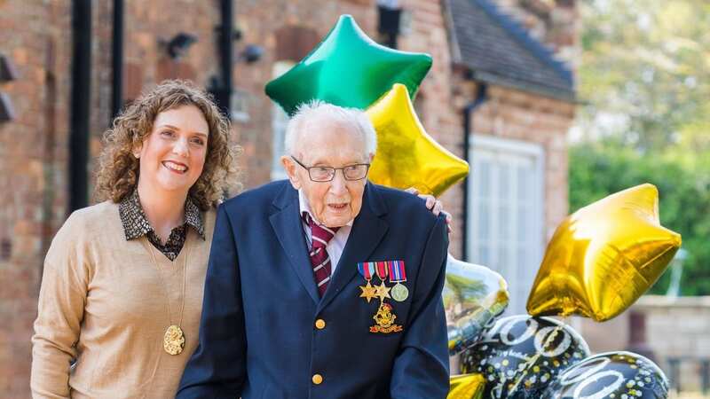 Tom Moore with his daughter Hannah Ingram-Moore outside his home after completing the 100th length of his back garden (Image: VICKIE FLORES/EPA-EFE/Shutterstock)