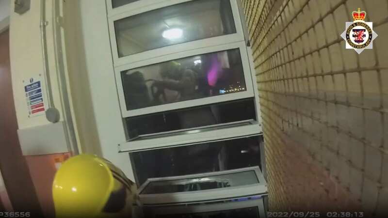 Terrifying moment two men cling to ledge at top of burning tower block