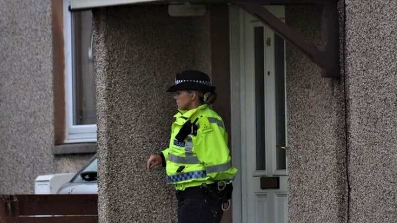 Officers outside the property in Stranraer, Dumfries and Galloway (Image: Jim Ryder)