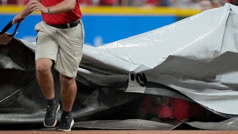 A crew member slipped and fell under the tarp and had to crawl out. (Image: ESPN)