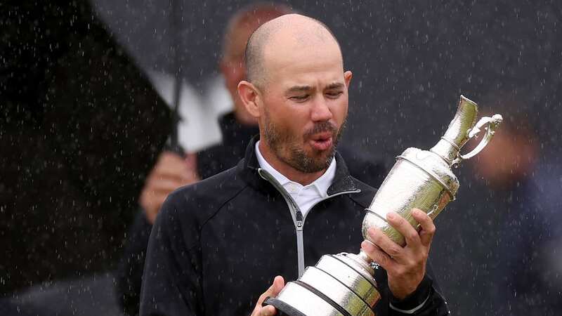 HOYLAKE, ENGLAND - JULY 23: Brian Harman of the United States reacts as they admire the Claret Jug after being presented with it on the 18th green on Day Four of The 151st Open at Royal Liverpool Golf Club on July 23, 2023 in Hoylake, England. (Photo by Gregory Shamus/Getty Images)