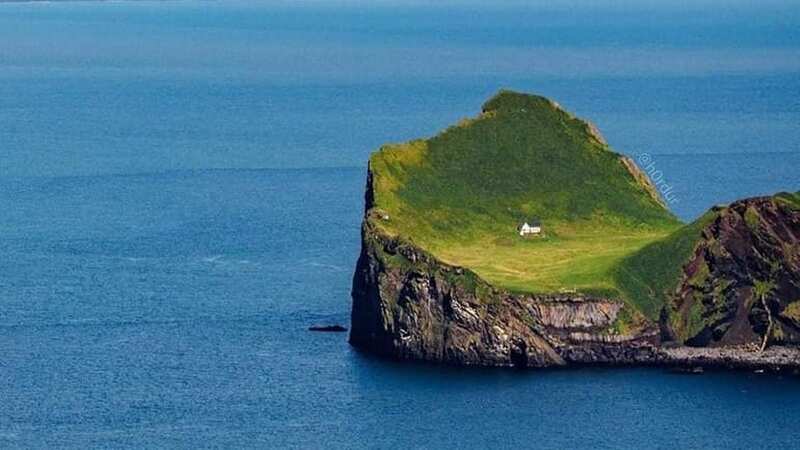 The tiny white house is the only building on the remote Icelandic island