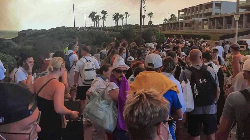 Tourists are evacuated from hotels during a wildfire on the Greek island of Rhodes on July 22, 2023. (Image: Eurokinissi/AFP via Getty Images)