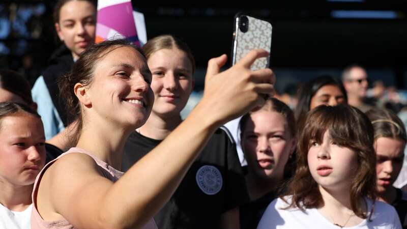Lotte poses for selfies with fans (Image: FIFA via Getty Images)