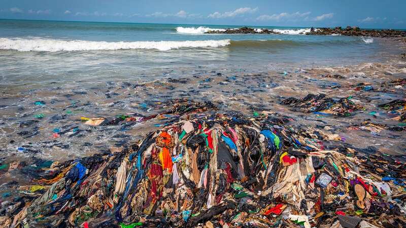 Mound of discarded clothes washed up on beach in Ghana (Image: Adam Gerrard / Daily Mirror)