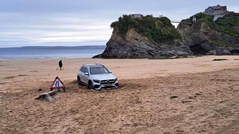 A driver has been mocked after getting their Mercedes stuck on a beach