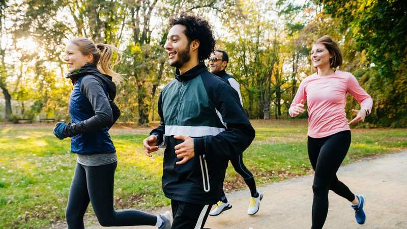 A group of joggers runs through a park (Image: Getty Images)