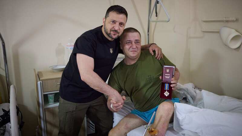 Volodymyr Zelensky with injured fighter (Image: APAImages/REX/Shutterstock)