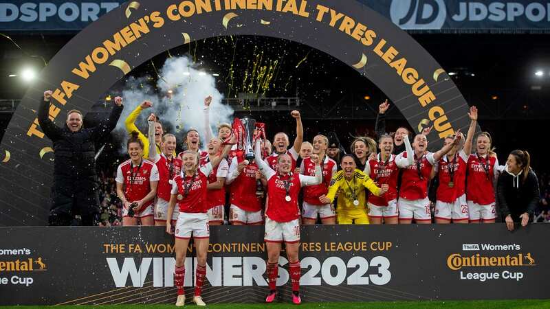 Leah Williamson and Kim Little of Arsenal lift the Conti Cup Trophy with their team mates after the FA Women