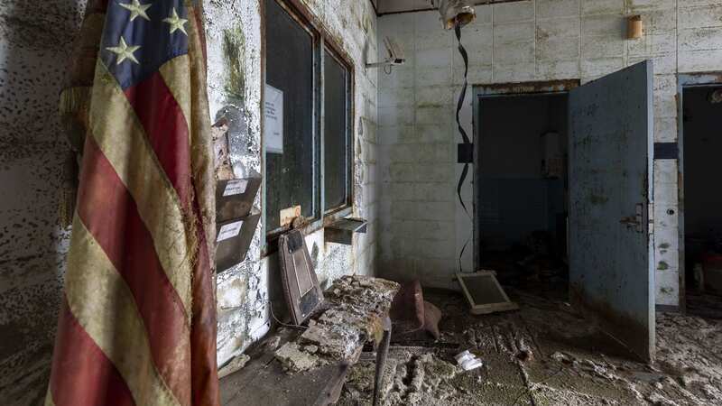 An American flag is left hanging and forgotten inside the detention centre (Image: mediadrumimages/Leland Kent)