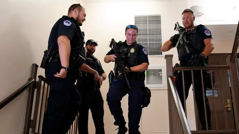 US Capitol Police officers clear a stairwell in the Dirksen Senate Office Building amid the scare today (Image: AP)