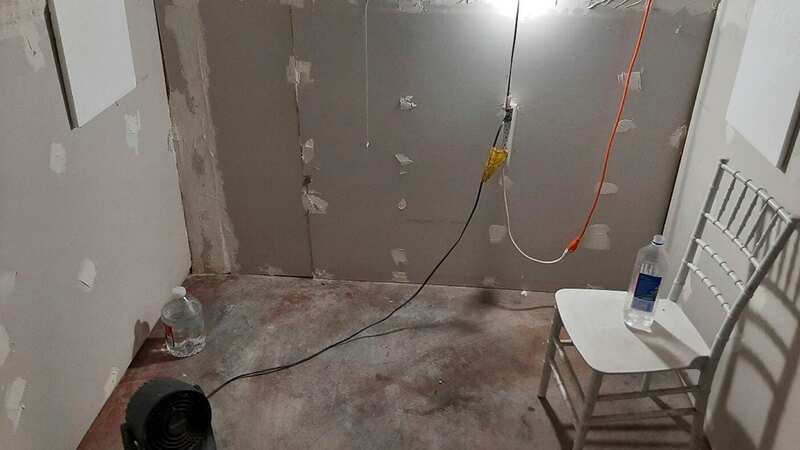 Images released by the FBI show exposed plaster and hanging wires along with a solitary chair in the makeshift cell (Image: AP)