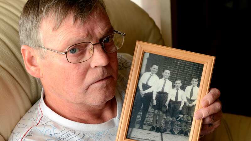 Terry Kilbride, 68, pictured holding a picture of his brother in the left of the frame, died on Saturday surrounded by his family, his partner Nicole said (Image: Sunday Mirror)