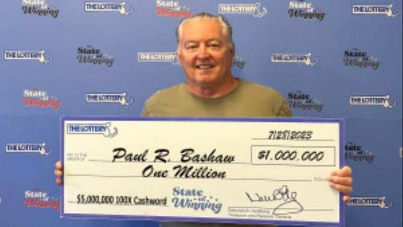 Paul Bashaw with his lottery winning cheque (Image: Jam Press)