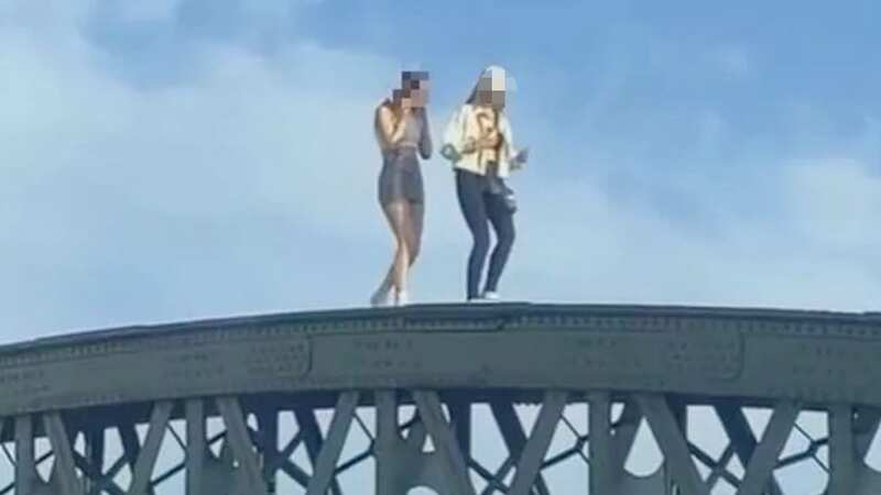 Two teenagers could be seen walking along the top of the steel girders