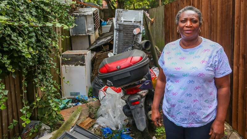 Like many other locals, Modupe Adejumo is disgusted by the rats and rubbish taking over her road (Image: Joseph Walshe / SWNS)