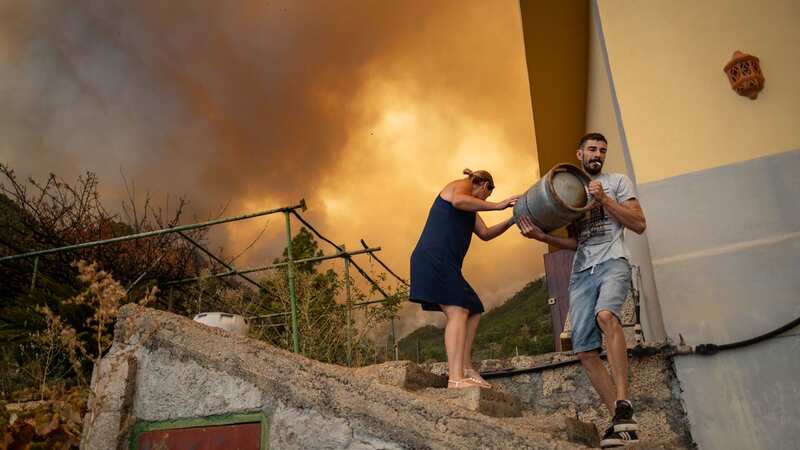 Residents remove explosives from their house as the wildfires get out of control in Tenerife (Image: Anadolu Agency via Getty Images)