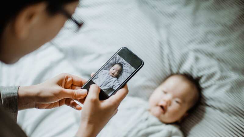 Two-thirds of parents regularly use their mobile phones to take photos, snapping an average of 23 pictures a week of their little ones (Image: Yiu Yu Hoi/Getty Images)