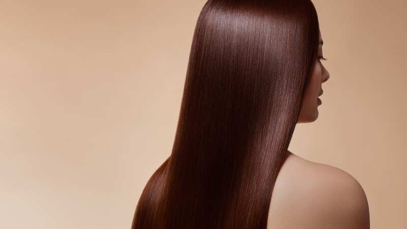 The spray aims to tame frizz and give you sleek, shiny locks (Image: Getty Images)