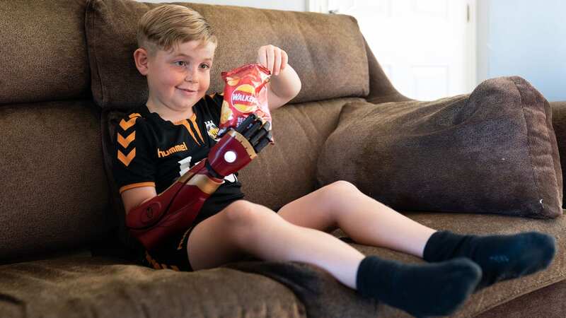 Louie Morgan-Kemp, seven, demonstrates his new prosthetic arm (Image: PA Wire)