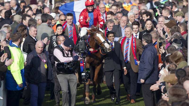 Jamie Moore celebrates after winning the Queen Elizabeth Queen Mother Champion Steeple Chase on Sire De Grugy (Image: Getty Images)