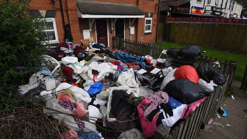 Rubbish is pictured in the front garden of the property (Image: BPM MEDIA)