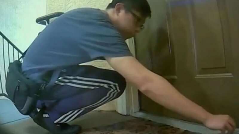 The neighbour appearing to inject a mysterious liquid under the door (Image: News Chanel 8)