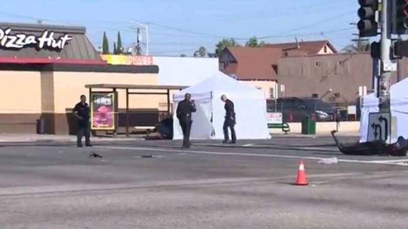 Bodies are covered by forensic tents at the harrowing scene (Image: CBS News)