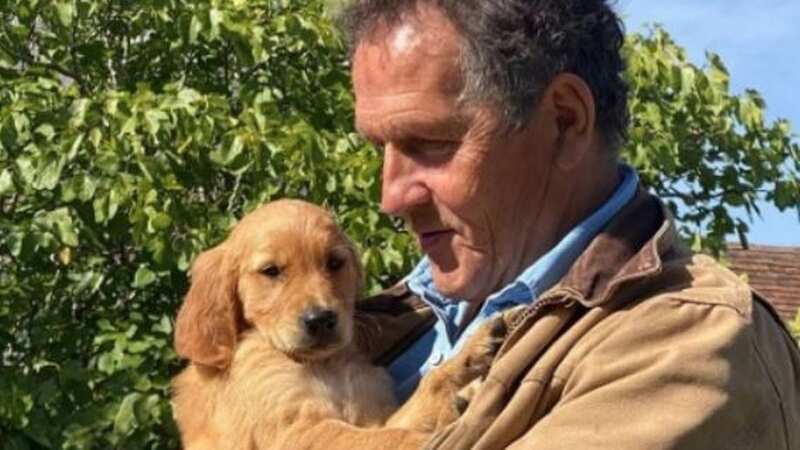 Monty Don cuddles up with one of his dogs Nellie after losing Brenda (Image: TheMontyDon/Twitter)