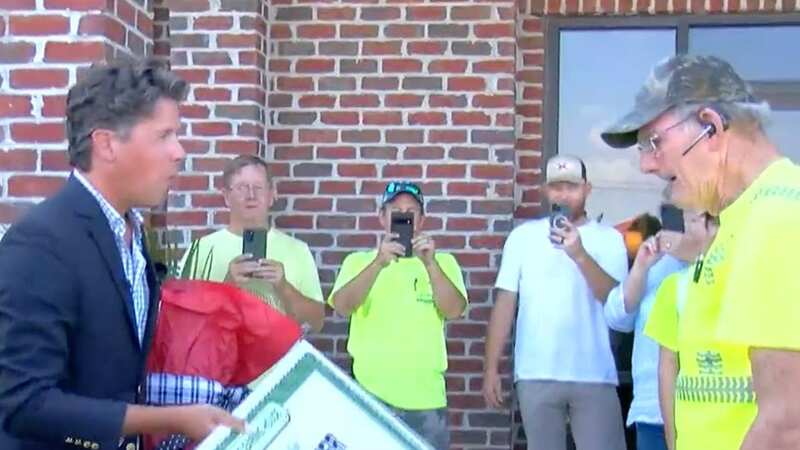 There was initially no sign of winner Edwin Walker, right, when prize-giver Howie Guja, left, arrived at his home (Image: waff)