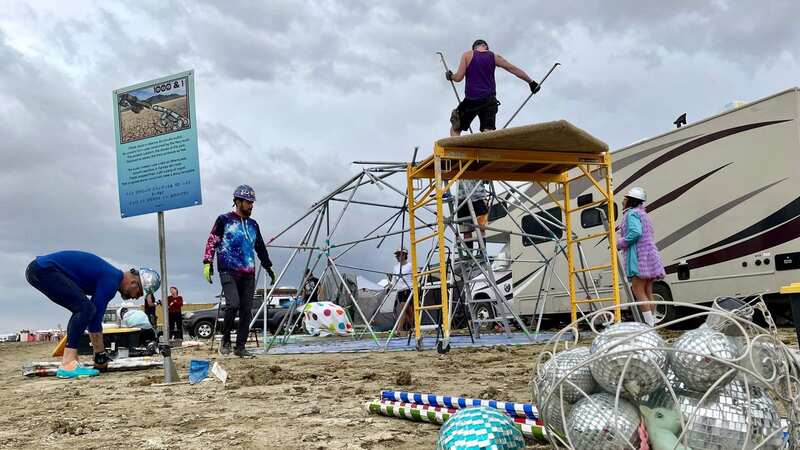Burning Man attendees pack down the camp before more rain hit (Image: AFP via Getty Images)