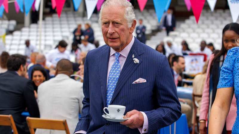 King Charles holds a cup of tea during the Big Jubilee Lunch at the Oval in London during June 2022 (Image: POOL/AFP via Getty Images)