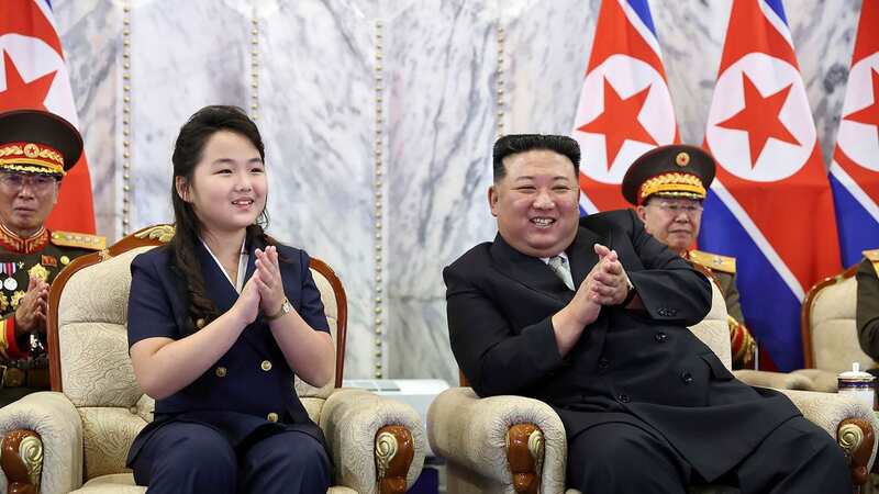 North Korea leader Kim Jong Un with his daughter, Kim Ju Ae, sat together to watch the parade (Image: AP)