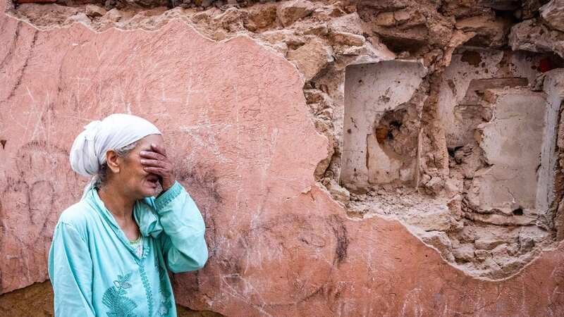 A womanstands in front of her earthquake-damaged house in Marrakesh (Image: AFP via Getty Images)