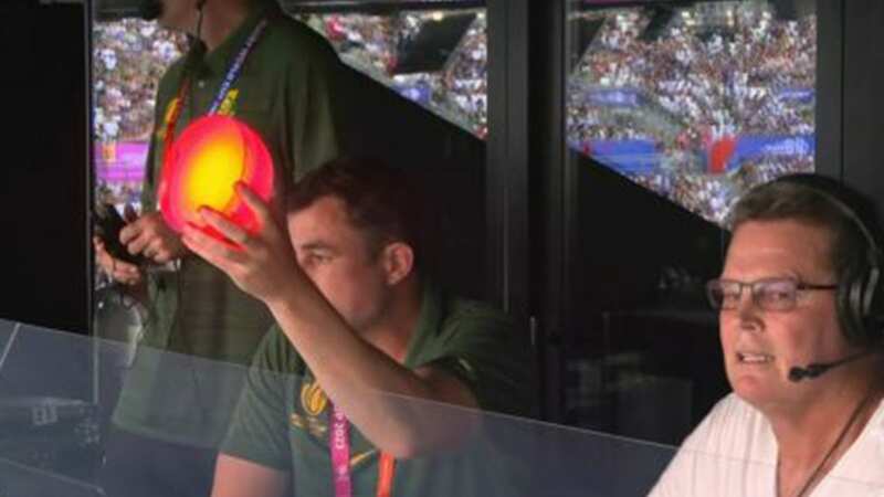 A South Africa coach holds up a light to signal the tactics to the players (Image: ITV)