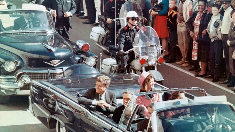 JFK was shot dead while riding in a presidential motorcade through Dealey Plaza in Dallas, Texas (Image: Bettmann Archive)