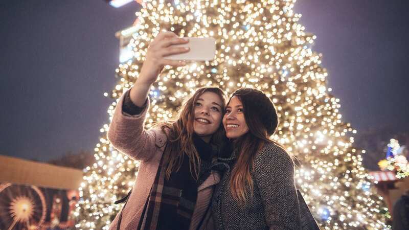 Share a selfie by the Christmas tree in Poland this year (Image: Getty)