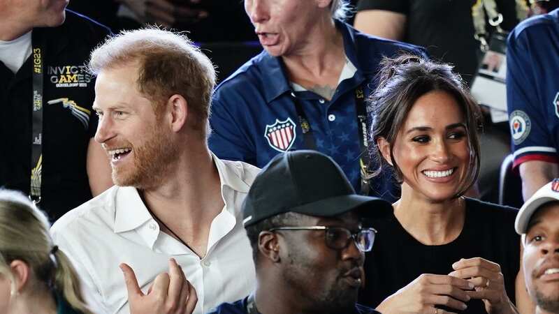Meghan and Harry all smiles as they join in with Sweet Caroline sing-along
