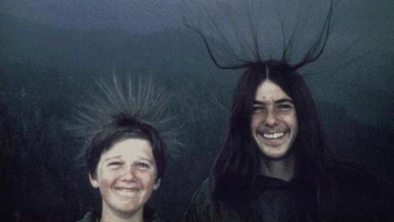 A haunting image shows two California brothers grinning, their hair standing on ende seconds before being struck by lightning (Image: Michael McQuilken)