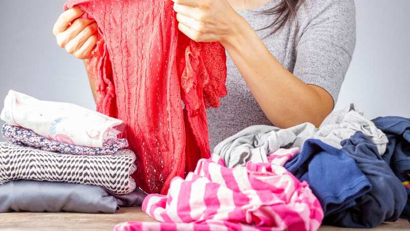 The cleaner was asked to fold a pile of clothes (stock photo) (Image: Getty Images/iStockphoto)