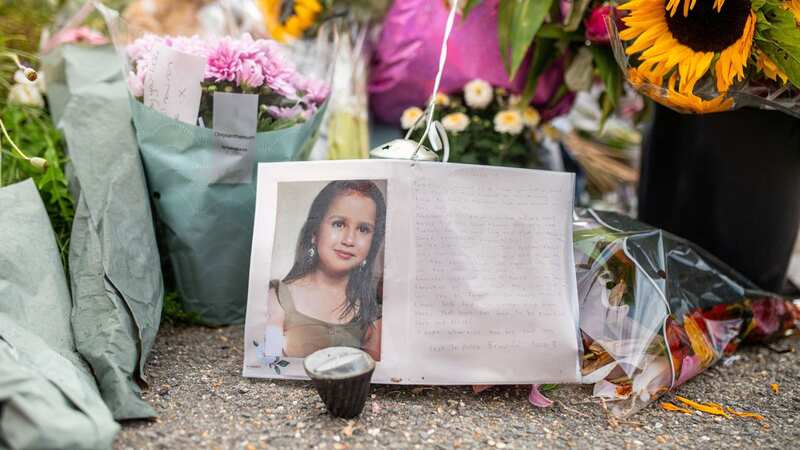 Tributes left to the young girl at her home in Woking, Surrey (Image: SWNS)