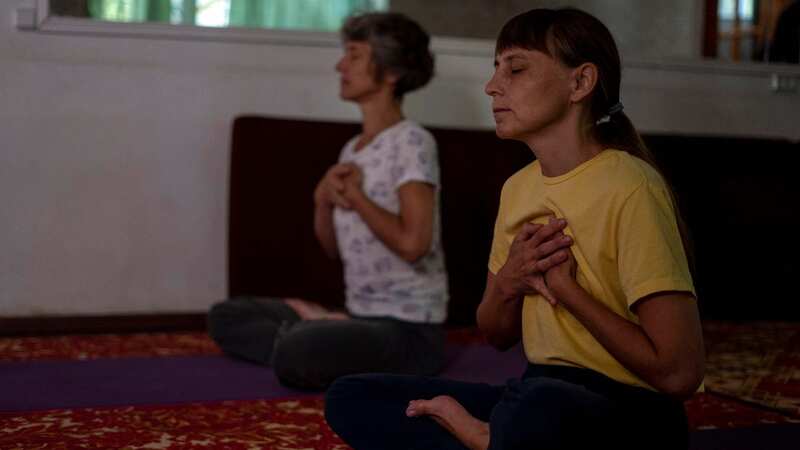 Viktoria Omelchenko, right, is practising yoga near the front-line of the conflict between Ukraine and Russia (Image: AP)