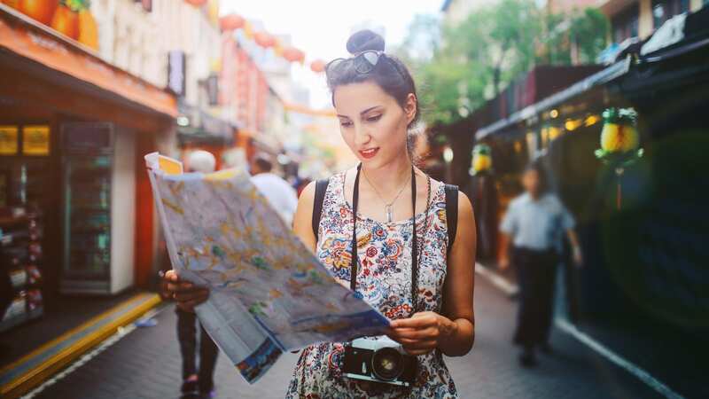 Stopping to check a map in the middle of the street is one of the top giveaways of being a tourist (Image: Getty Images)