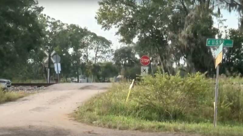 The crossing has no barriers, just a stop sign warning drivers of passing trains (Image: WFLA)