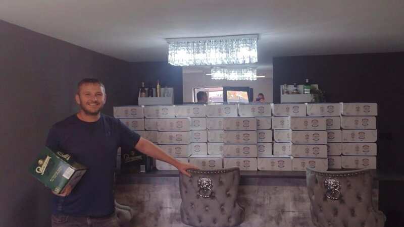 Stuart Hardy with the cases of Peroni at his home bar (Image: Jam Press)