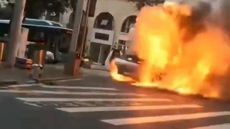 Dramatic moment £200k car bursts into flames - firefighters fight for control
